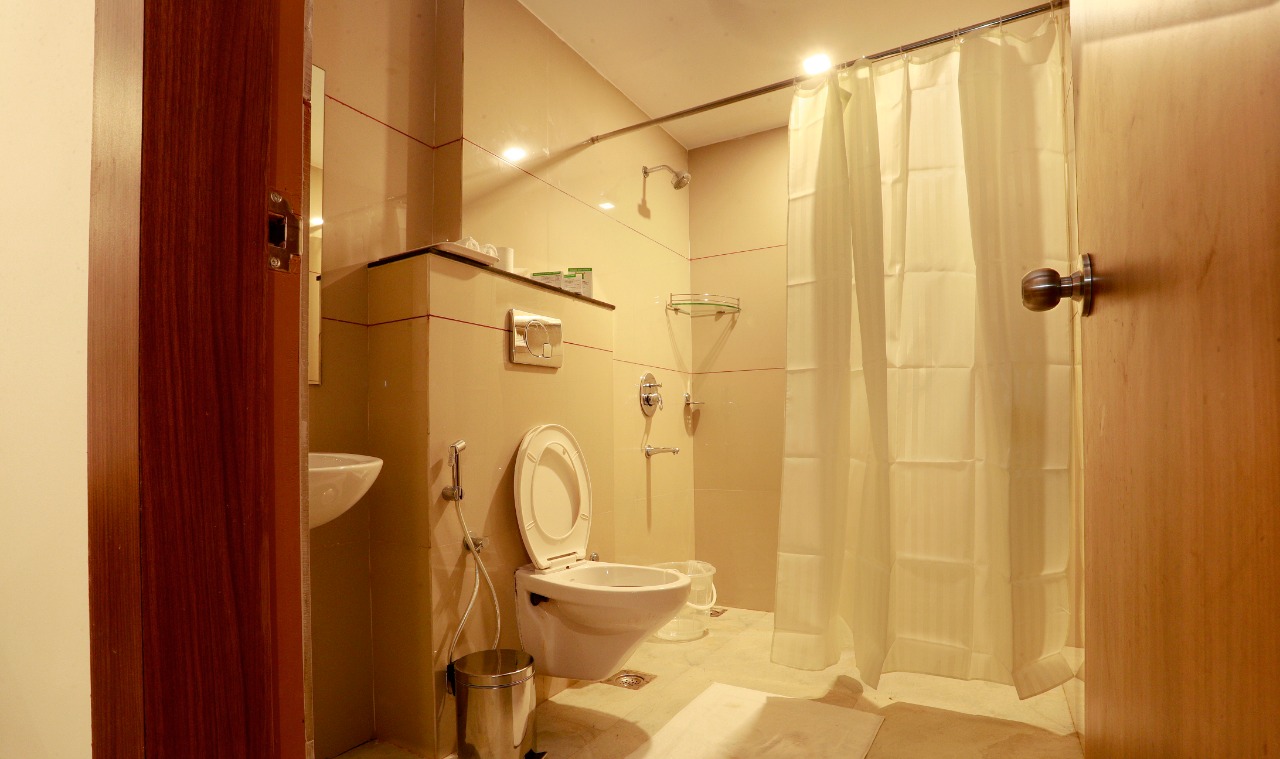 Attached modern bathroom with shower and vanity